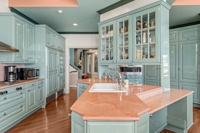 1416 Bay Blvd, Atlantic Beach, NY 11509 - kitchen featuring stainless steel microwave, wood finished floors, light countertops, recessed lighting, and a kitchen island with sink
