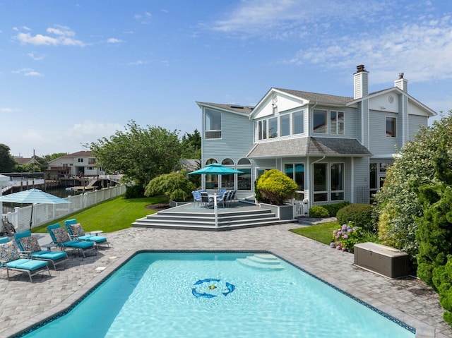 1416 Bay Blvd, Atlantic Beach, NY 11509 - back of house with a patio area, an outdoor pool, outdoor dining area, and a chimney