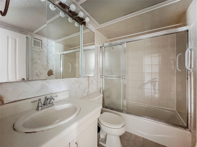 203 Dover Grn, Staten Island, NY 10312 - full bathroom featuring vanity, bath / shower combo with glass door, toilet, tile patterned flooring, and decorative backsplash