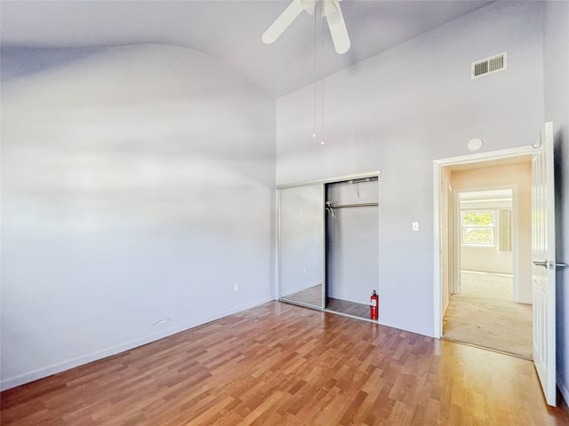 203 Dover Grn, Staten Island, NY 10312 - unfurnished bedroom with light wood finished floors, high vaulted ceiling, a closet, a ceiling fan, and baseboards