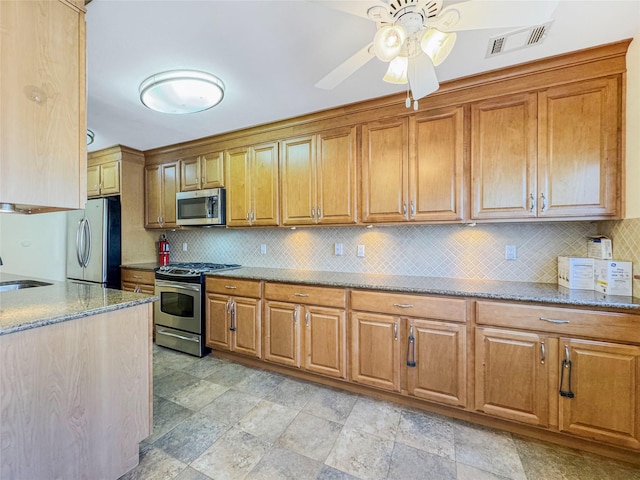 203 Dover Grn, Staten Island, NY 10312 - kitchen with stainless steel appliances, light stone counters, brown cabinets, decorative backsplash, and a sink