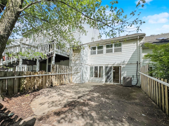 203 Dover Grn, Staten Island, NY 10312 - back of house with central AC unit, a fenced backyard, and a patio