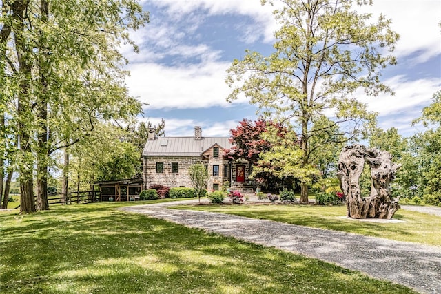 26 Roberson Ave, Pine Bush, NY 12566 - view of front of house with a chimney, a front yard, and metal roof