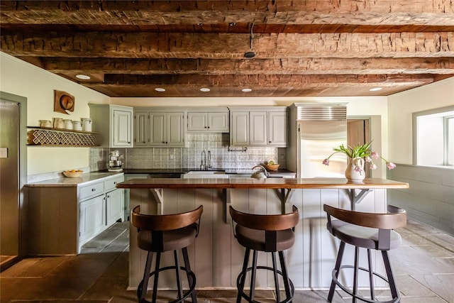 26 Roberson Ave, Pine Bush, NY 12566 - kitchen with a sink, a breakfast bar area, backsplash, and built in fridge