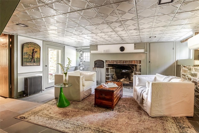 26 Roberson Ave, Pine Bush, NY 12566 - living room featuring radiator heating unit, a brick fireplace, and an ornate ceiling