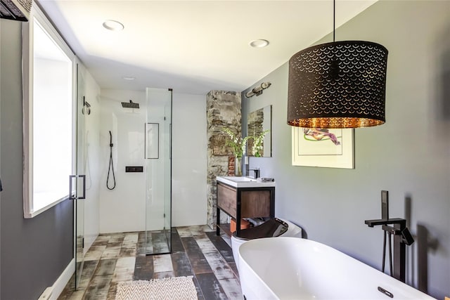 26 Roberson Ave, Pine Bush, NY 12566 - bathroom featuring a stall shower, a soaking tub, vanity, wood finished floors, and recessed lighting