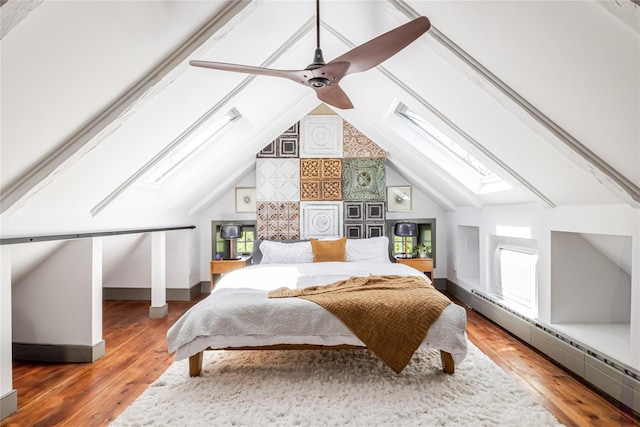 26 Roberson Ave, Pine Bush, NY 12566 - bedroom with a skylight, a baseboard heating unit, hardwood / wood-style flooring, lofted ceiling, and baseboards