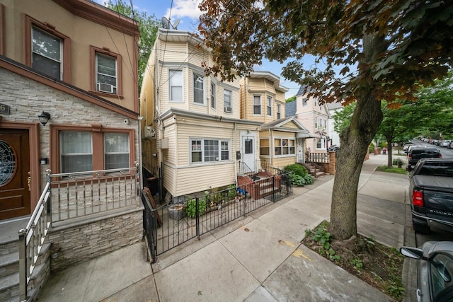 8564 79th St, Woodhaven, NY 11421 - townhome / multi-family property with entry steps, a residential view, and cooling unit