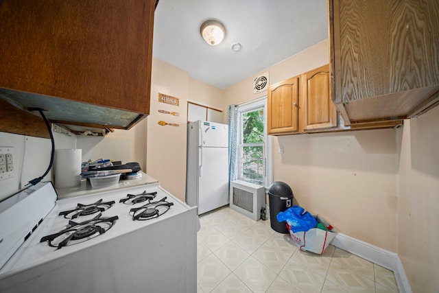 8564 79th St, Woodhaven, NY 11421 - kitchen featuring white appliances, baseboards, light tile patterned floors, and light countertops