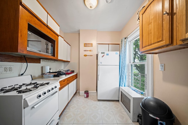 8564 79th St, Woodhaven, NY 11421 - kitchen featuring white appliances, light countertops, baseboards, brown cabinets, and light tile patterned floors