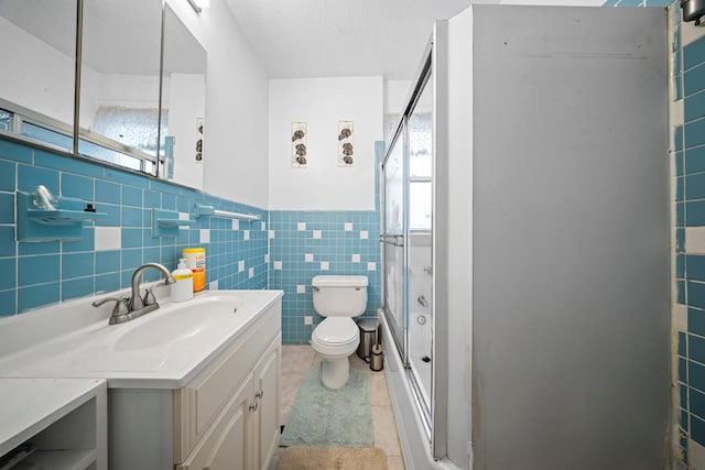 8564 79th St, Woodhaven, NY 11421 - bathroom featuring tile walls, toilet, vanity, tile patterned flooring, and healthy amount of natural light