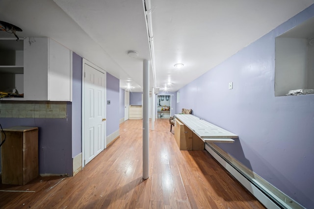 8564 79th St, Woodhaven, NY 11421 - corridor with a baseboard heating unit and wood finished floors