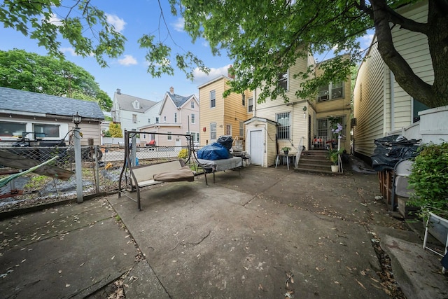 8564 79th St, Woodhaven, NY 11421 - rear view of property with a residential view and a patio