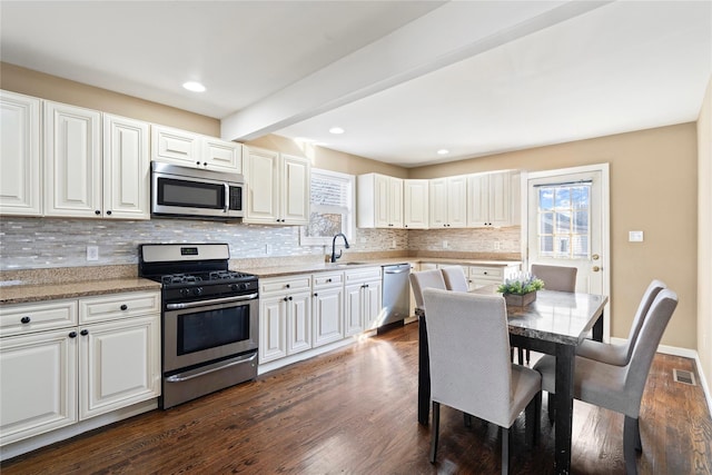 49 Anderson Ave, North Babylon, NY 11703 - kitchen featuring stainless steel appliances, a sink, plenty of natural light, backsplash, and beam ceiling