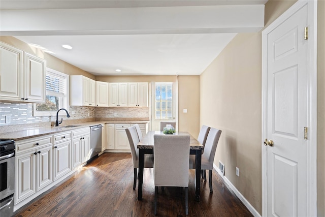 49 Anderson Ave, North Babylon, NY 11703 - kitchen featuring stainless steel dishwasher, a sink, healthy amount of natural light, dark wood-type flooring, and recessed lighting