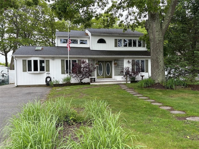 8 Sachs St, Bay Shore, NY 11706 - view of front of property with a front yard, asphalt driveway, and roof with shingles