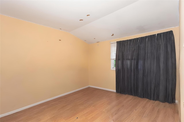 1340 Lombardy Blvd, Bay Shore, NY 11706 - unfurnished room featuring vaulted ceiling, light wood-style flooring, and baseboards