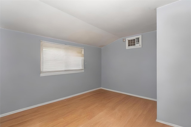 1340 Lombardy Blvd, Bay Shore, NY 11706 - empty room with vaulted ceiling, light wood-type flooring, and baseboards