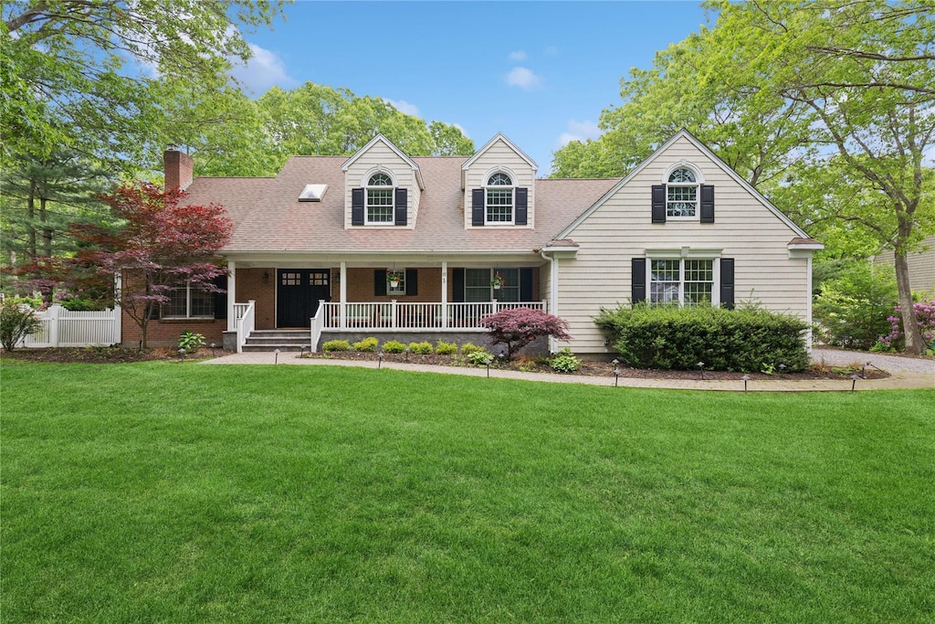 15 Shelter Harbor Ct, Wading River, NY 11792 - cape cod home with a front yard, covered porch, a chimney, and roof with shingles