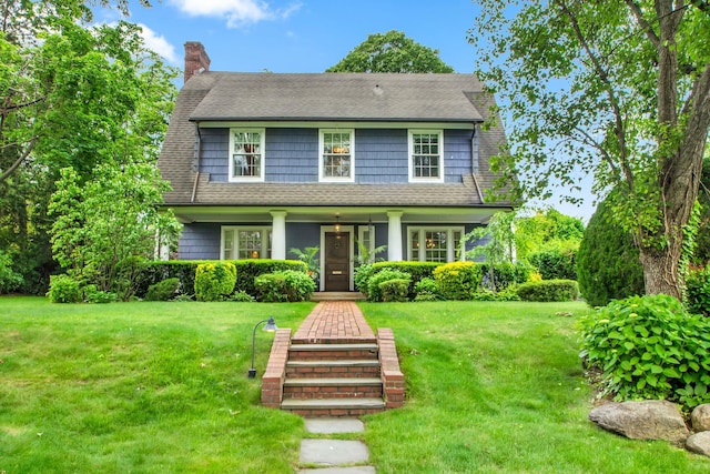 7 Middle Dr, Manhasset, NY 11030 - view of front of property featuring covered porch, a front lawn, a chimney, and roof with shingles