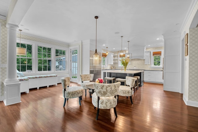 7 Middle Dr, Manhasset, NY 11030 - dining area featuring wallpapered walls, dark wood-style flooring, crown molding, decorative columns, and baseboards