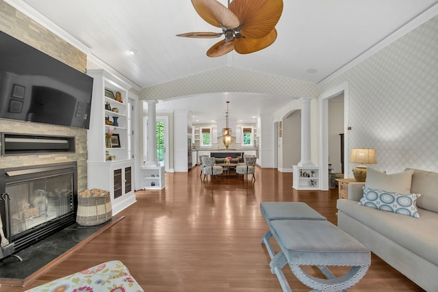 7 Middle Dr, Manhasset, NY 11030 - living area with ornate columns, wallpapered walls, a ceiling fan, wood finished floors, and a stone fireplace