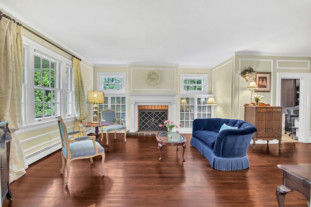 7 Middle Dr, Manhasset, NY 11030 - living room featuring a baseboard heating unit, ornamental molding, a brick fireplace, wood finished floors, and a decorative wall