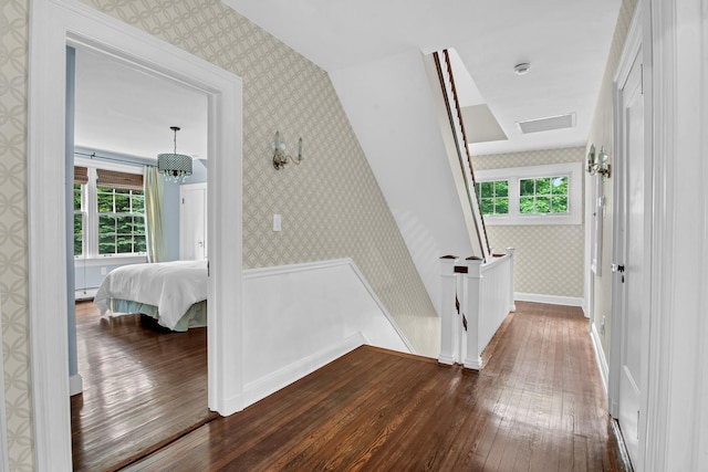 7 Middle Dr, Manhasset, NY 11030 - corridor featuring wallpapered walls, dark wood-style floors, plenty of natural light, wainscoting, and an upstairs landing