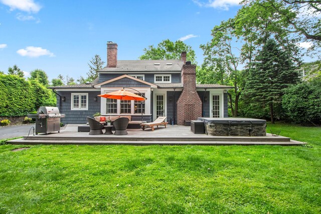 7 Middle Dr, Manhasset, NY 11030 - back of property with a wooden deck, a hot tub, an outdoor living space, and a chimney