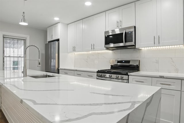 4163 Laconia Ave, Bronx, NY 10466 - kitchen with stainless steel appliances, a sink, an island with sink, white cabinets, and recessed lighting