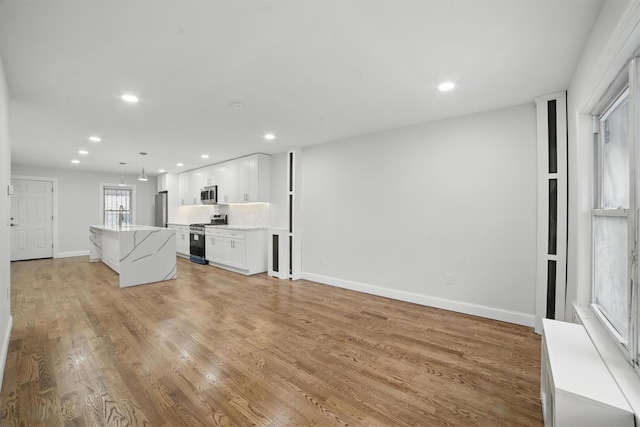 4163 Laconia Ave, Bronx, NY 10466 - unfurnished living room featuring recessed lighting, light wood-style flooring, and baseboards