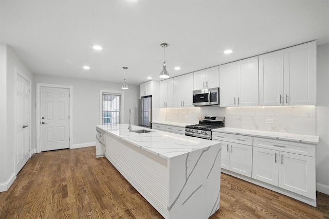 4163 Laconia Ave, Bronx, NY 10466 - kitchen featuring appliances with stainless steel finishes, white cabinetry, tasteful backsplash, a sink, and recessed lighting