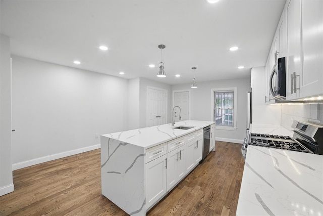 4163 Laconia Ave, Bronx, NY 10466 - kitchen with a sink, stainless steel appliances, recessed lighting, white cabinets, and a center island with sink