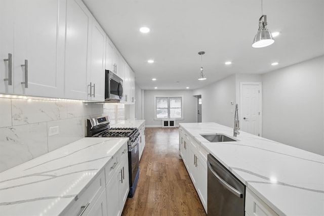 4163 Laconia Ave, Bronx, NY 10466 - kitchen with appliances with stainless steel finishes, a sink, wood finished floors, white cabinets, and recessed lighting
