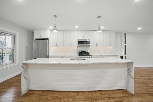4163 Laconia Ave, Bronx, NY 10466 - kitchen with appliances with stainless steel finishes, decorative backsplash, a large island with sink, white cabinets, and recessed lighting