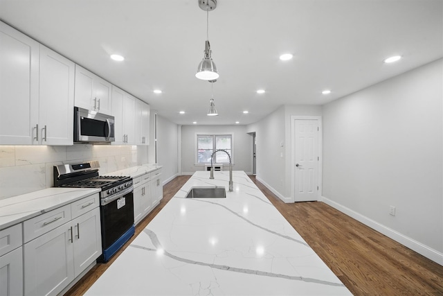 4163 Laconia Ave, Bronx, NY 10466 - kitchen with appliances with stainless steel finishes, a sink, recessed lighting, white cabinetry, and baseboards