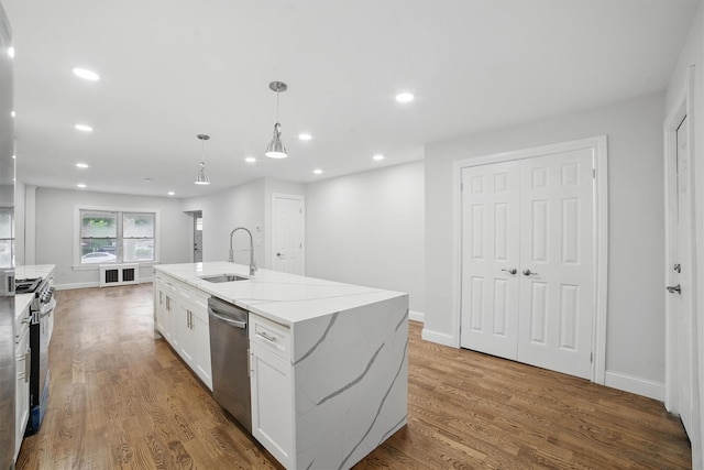 4163 Laconia Ave, Bronx, NY 10466 - kitchen with a sink, stainless steel appliances, white cabinets, recessed lighting, and a kitchen island with sink