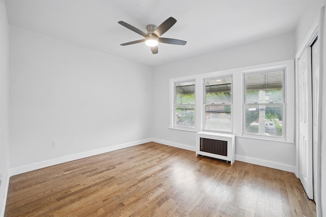 4163 Laconia Ave, Bronx, NY 10466 - empty room with radiator heating unit, wood finished floors, baseboards, and a ceiling fan