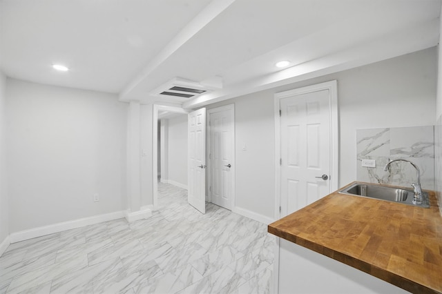 4163 Laconia Ave, Bronx, NY 10466 - finished below grade area with a sink, light marble finish floors, baseboards, and recessed lighting