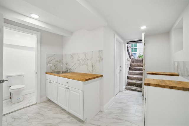 4163 Laconia Ave, Bronx, NY 10466 - indoor wet bar with light marble finish floors, recessed lighting, and stairs