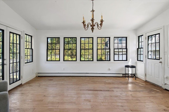610 Farm To Market Rd, Brewster, NY 10509 - unfurnished dining area featuring a chandelier, light wood-style flooring, a baseboard heating unit, baseboards, and lofted ceiling