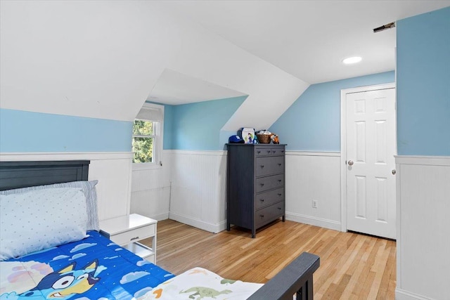 610 Farm To Market Rd, Brewster, NY 10509 - bedroom featuring a wainscoted wall, wood finished floors, and vaulted ceiling