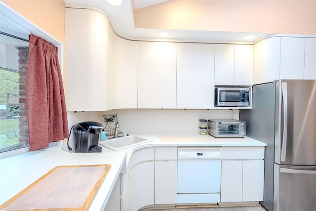 45 Broadview Dr, Commack, NY 11725 - kitchen featuring stainless steel appliances, light countertops, a sink, white cabinetry, and modern cabinets
