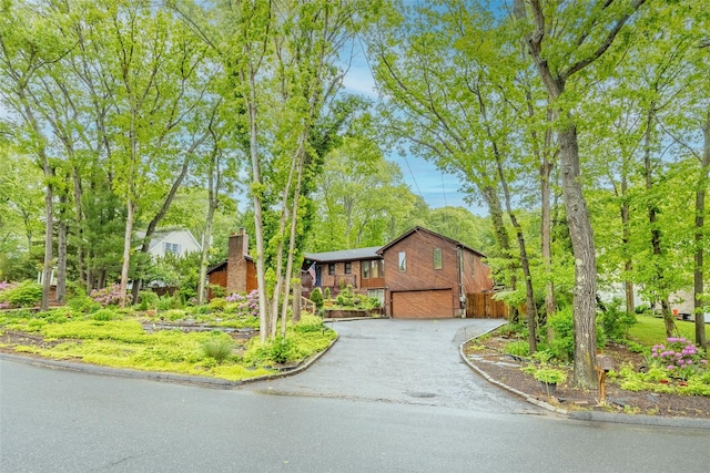 45 Broadview Dr, Commack, NY 11725 - ranch-style home with an attached garage, asphalt driveway, and a chimney