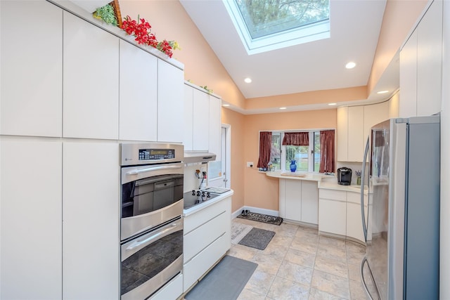 45 Broadview Dr, Commack, NY 11725 - kitchen featuring appliances with stainless steel finishes, baseboards, a skylight, light countertops, and white cabinets