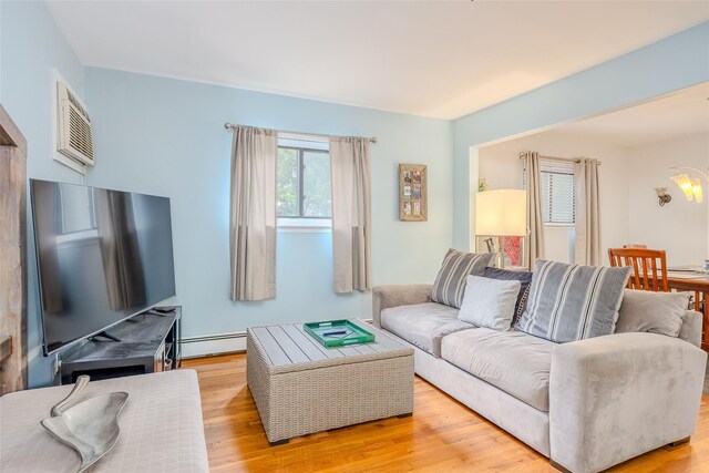 45 Broadview Dr, Commack, NY 11725 - living area featuring a baseboard heating unit, light wood-style floors, and a chandelier