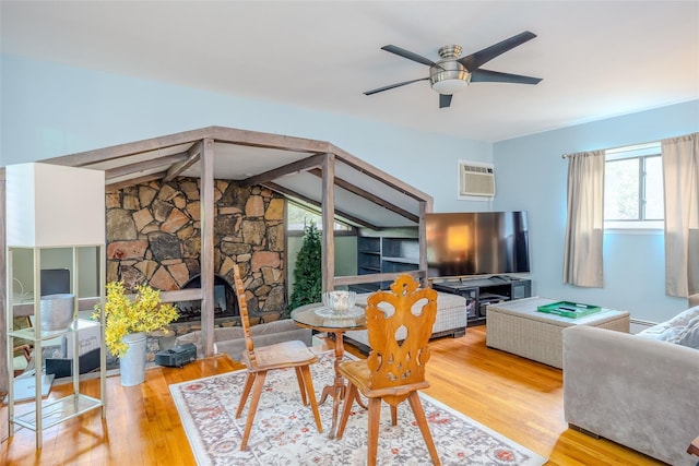 45 Broadview Dr, Commack, NY 11725 - living area featuring wood finished floors, a ceiling fan, a wall unit AC, a stone fireplace, and beam ceiling