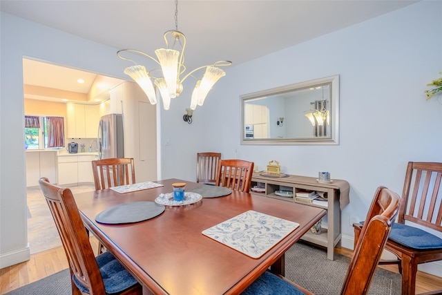 45 Broadview Dr, Commack, NY 11725 - dining space with light wood-type flooring, a chandelier, and baseboards