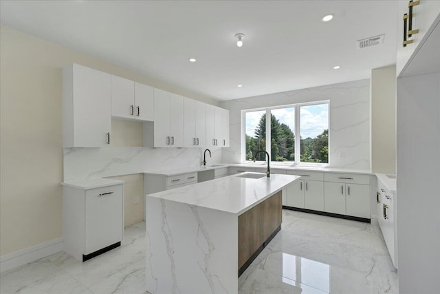 42 Greycourt Rd, Chester, NY 10918 - kitchen featuring backsplash, an island with sink, recessed lighting, light marble finish flooring, and light stone counters
