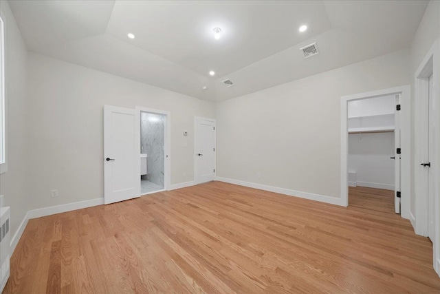 42 Greycourt Rd, Chester, NY 10918 - unfurnished bedroom with light wood finished floors, a spacious closet, baseboards, ensuite bathroom, and recessed lighting